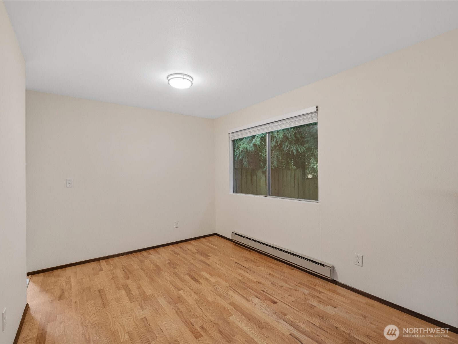8506 192nd Street Southwest Edmonds, WA 98026 - Photo 13 of 37 a view of an empty room with wooden floor and a window