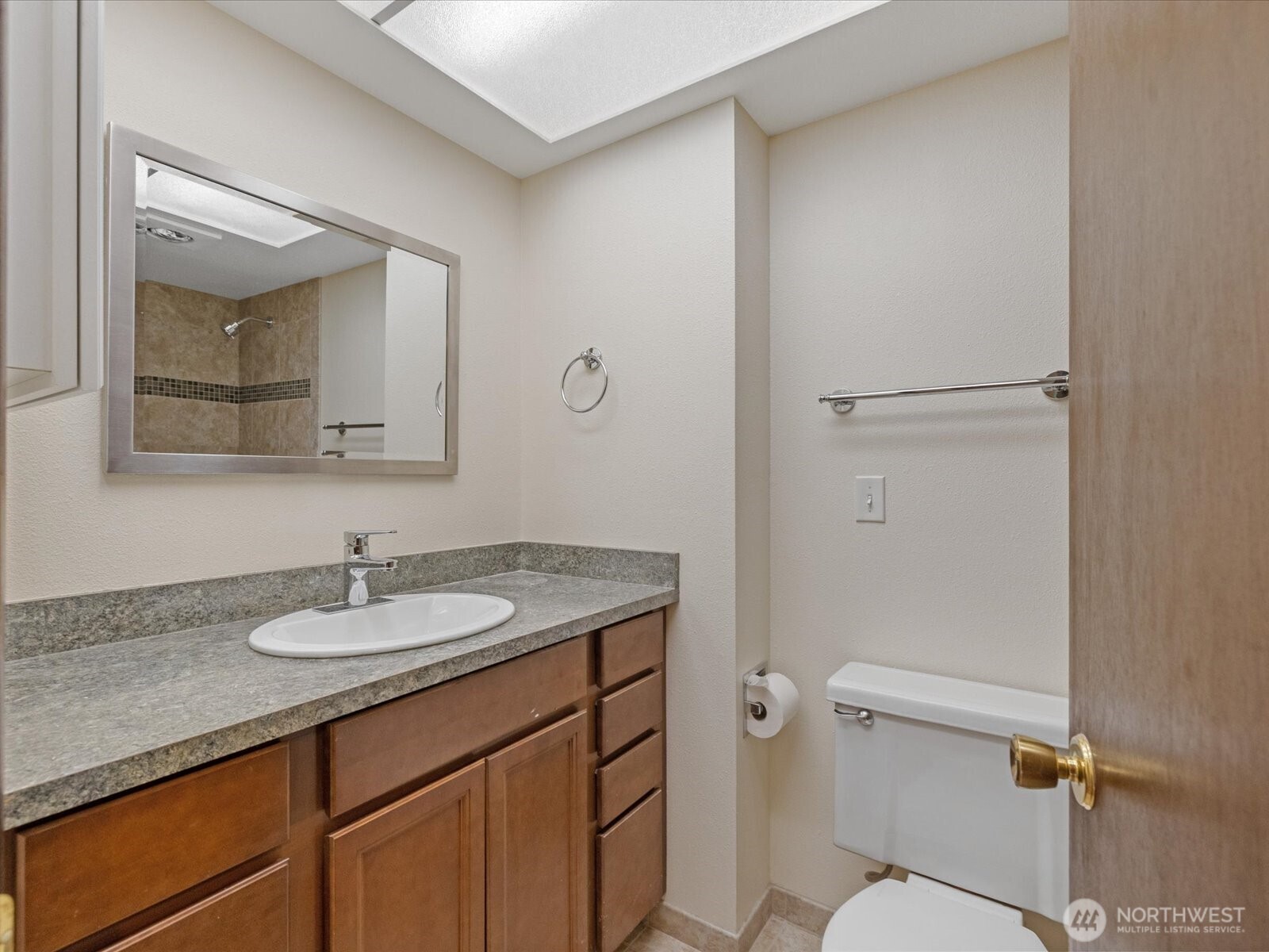 8506 192nd Street Southwest Edmonds, WA 98026 - Photo 23 of 37 a bathroom with a granite countertop sink toilet and mirror