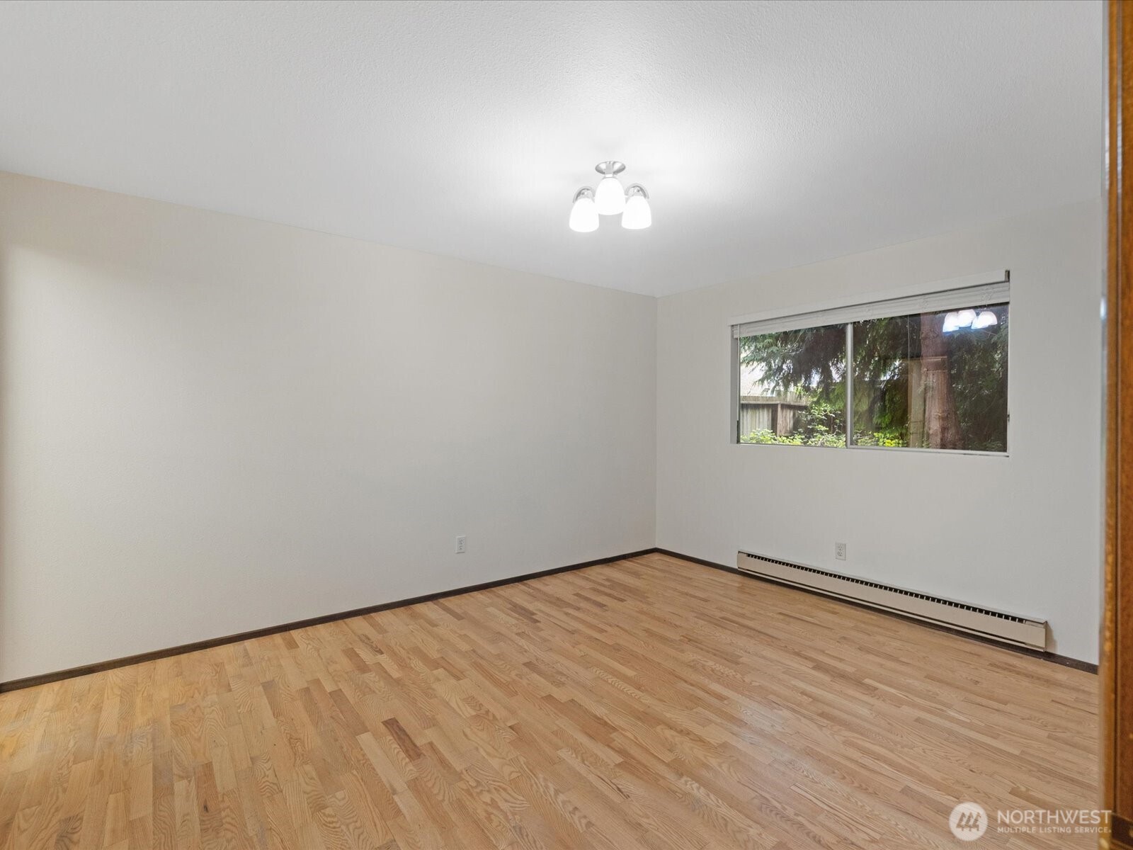8506 192nd Street Southwest Edmonds, WA 98026 - Photo 24 of 37 a view of an empty room with wooden floor and a window