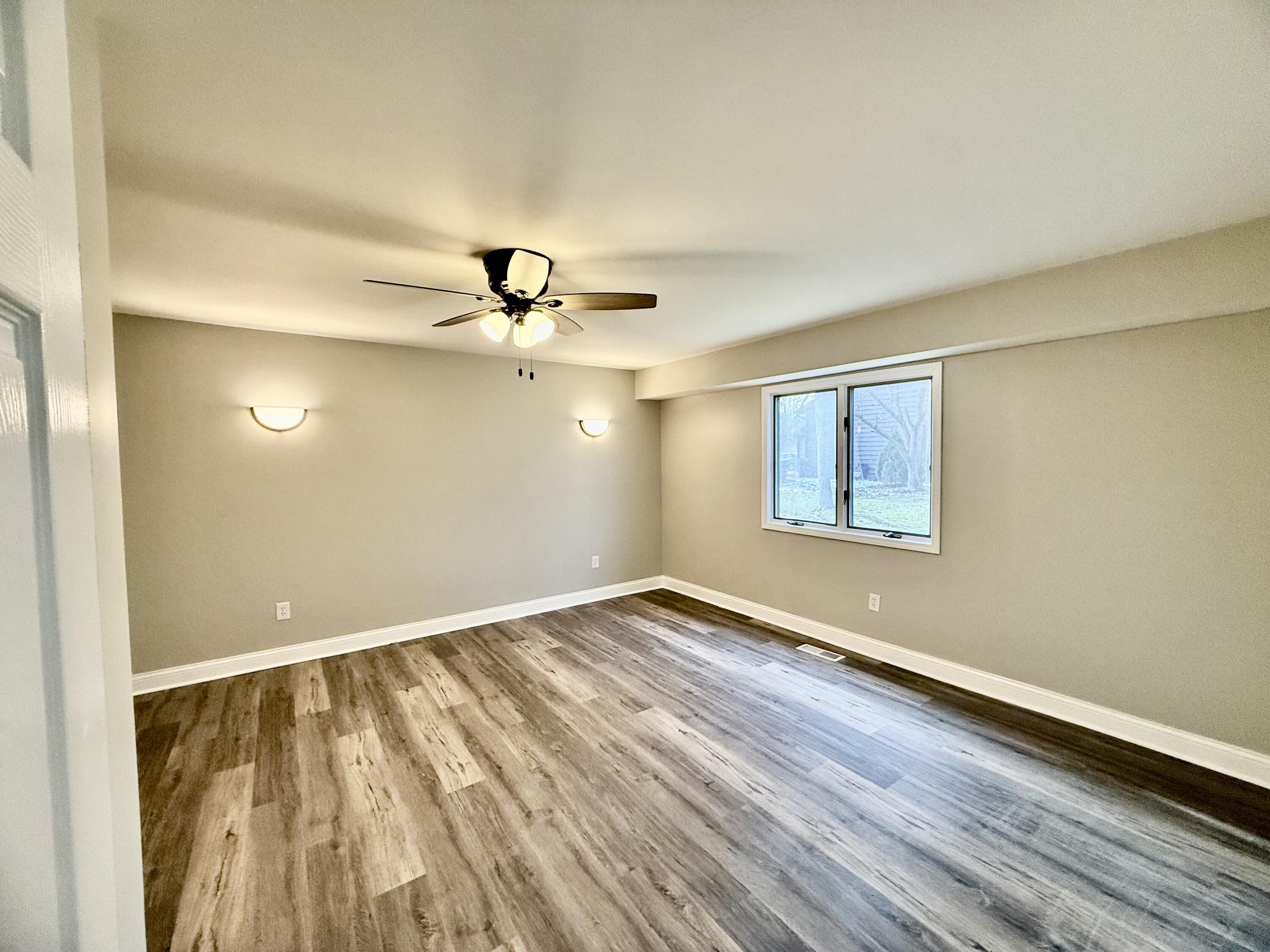 1962 Aspen Court Crown Point, IN 46307 - Photo 14 of 27 wooden floor in an empty room with a window
