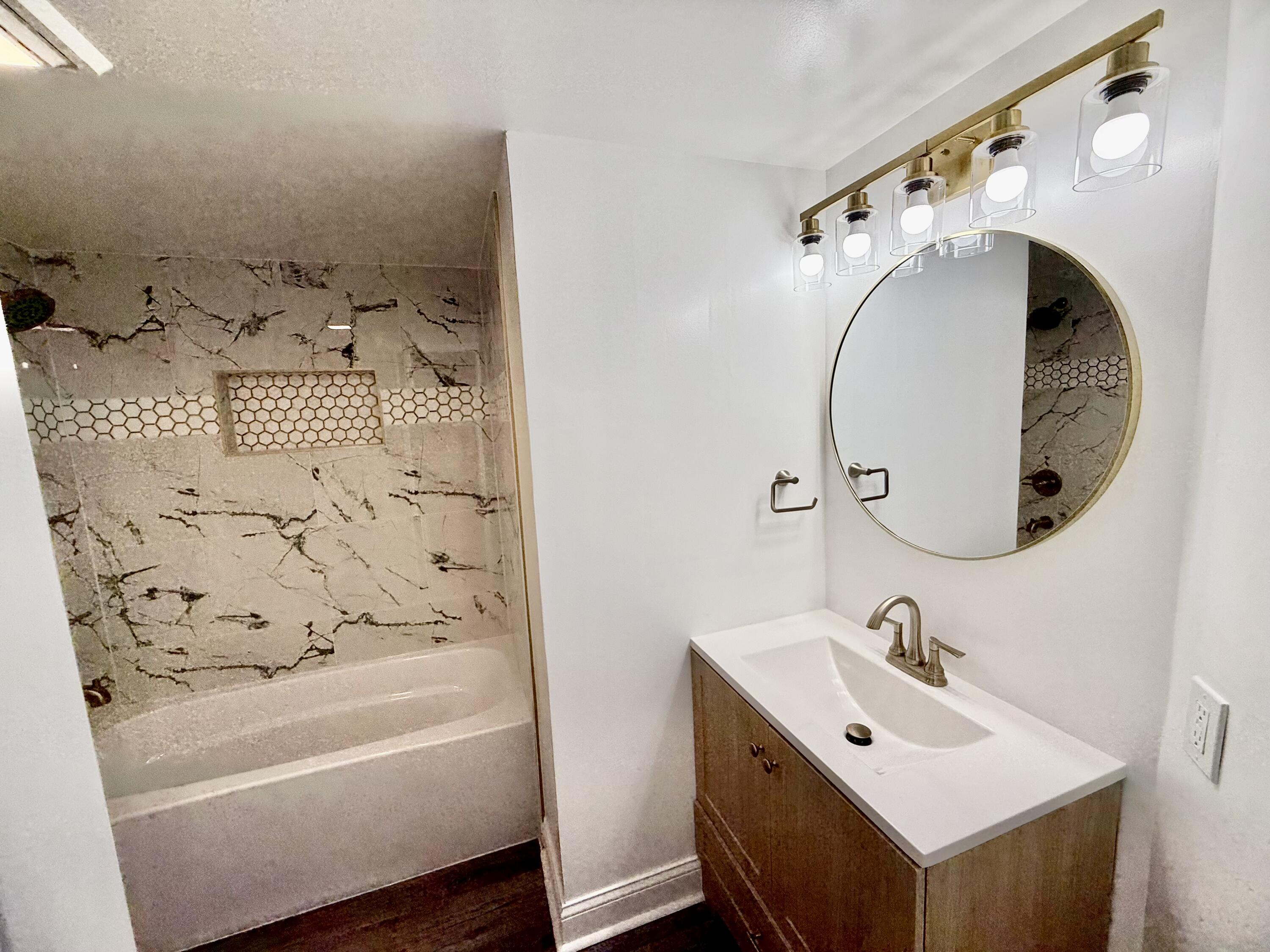 1962 Aspen Court Crown Point, IN 46307 - Photo 16 of 27 a bathroom with a sink and mirror with bathtub