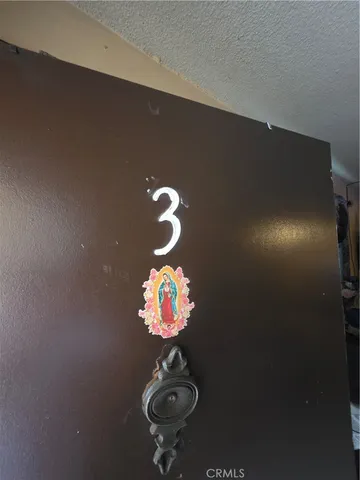 a kitchen with refrigerator and chairs