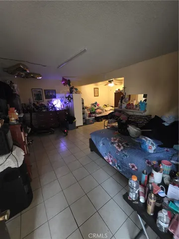 a bedroom with a bed and a ceiling fan