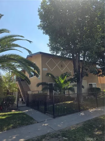 a view of a house with a tree in front of it