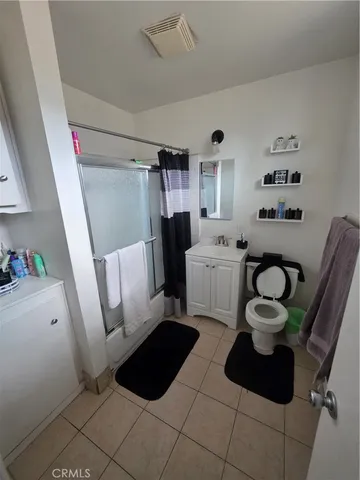 a living room with furniture a rug and a table