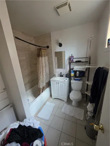 a bed sitting in a bedroom next to a lamp