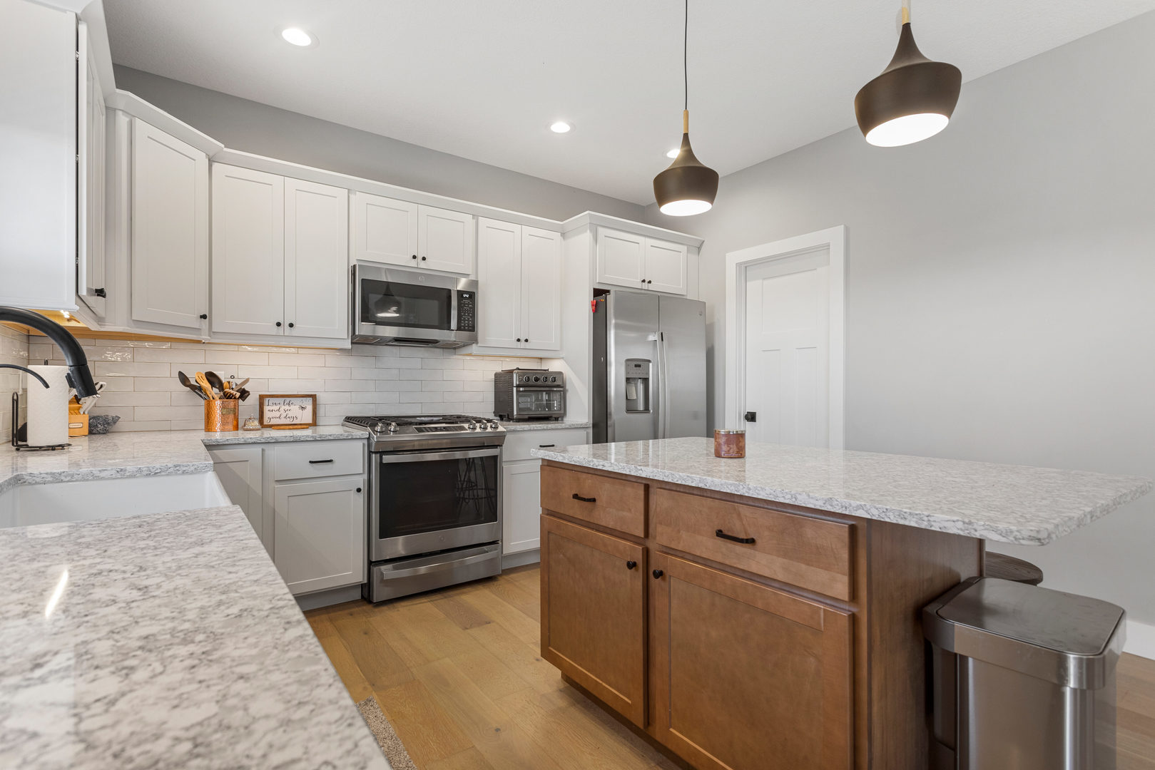 103 Wildflower Heyworth, IL 61745 - Photo 13 of 39 a kitchen with stainless steel appliances granite countertop a stove top oven a sink and white cabinets