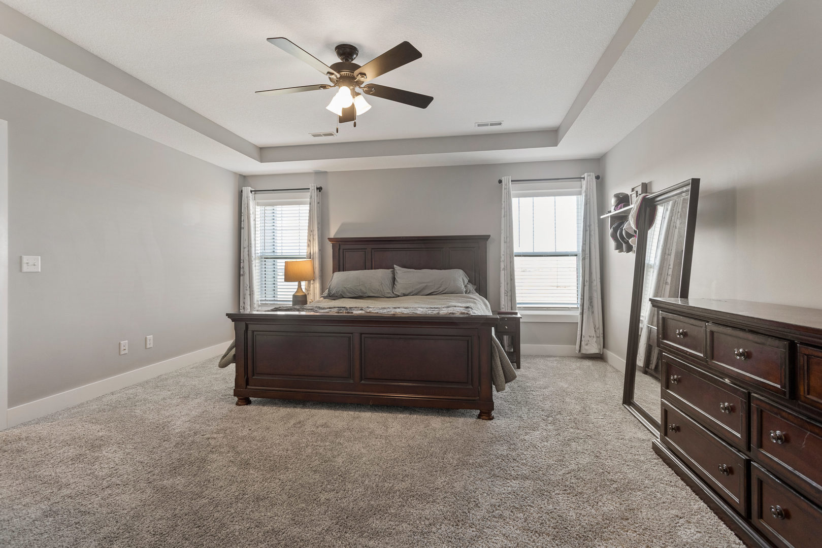 103 Wildflower Heyworth, IL 61745 - Photo 18 of 39 a spacious bedroom with a bed and a chandelier