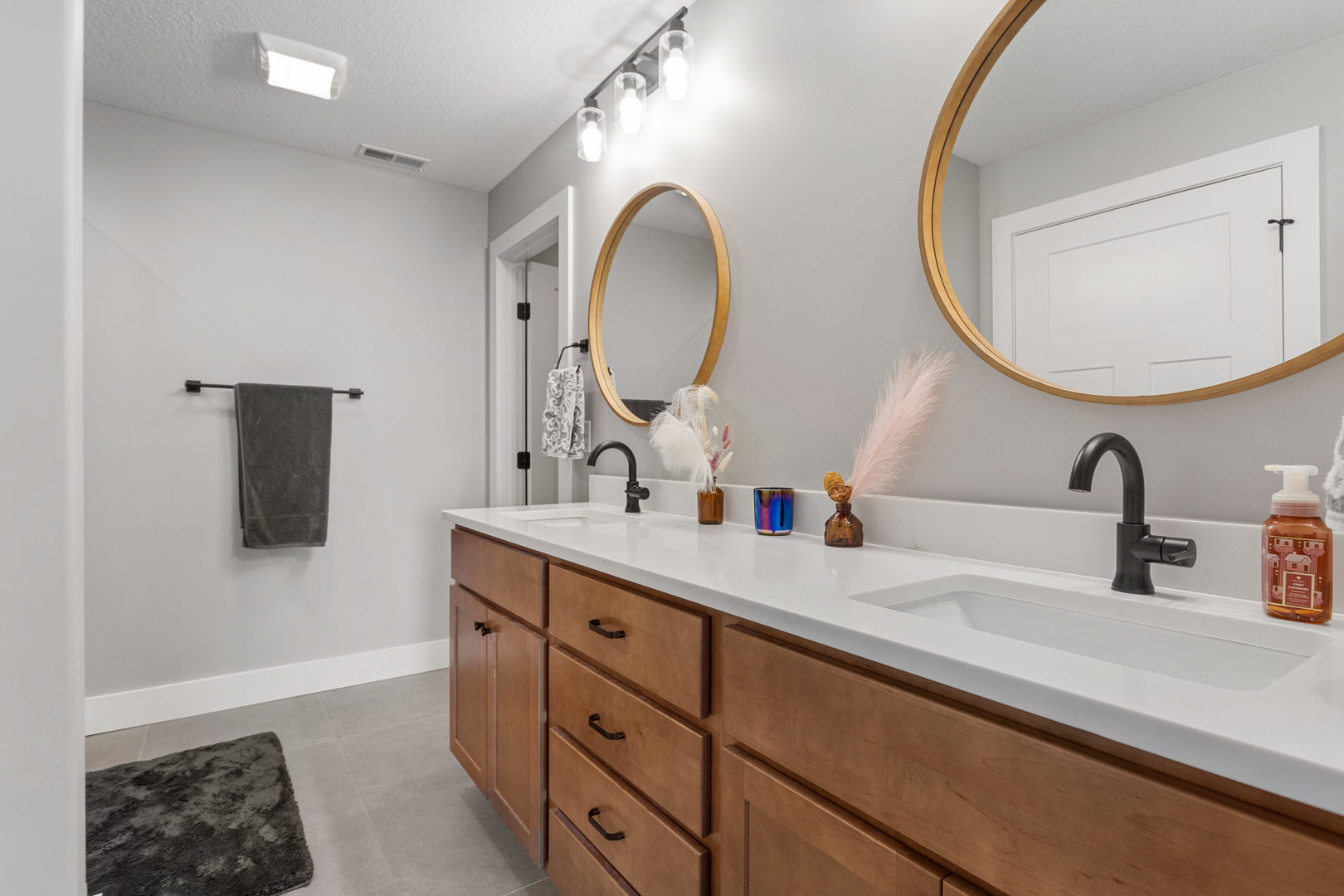 103 Wildflower Heyworth, IL 61745 - Photo 19 of 39 a bathroom with a double vanity sink and a mirror