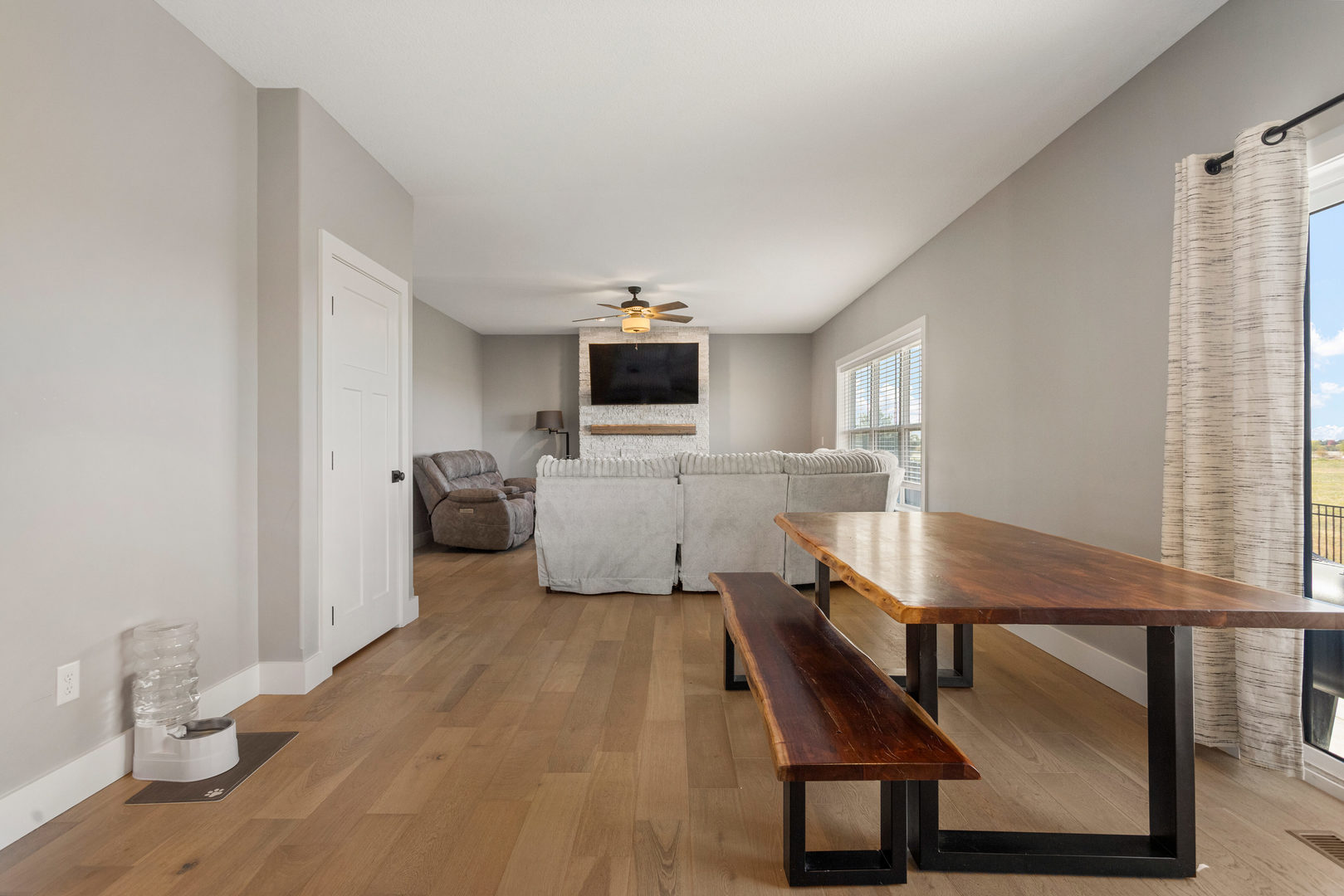 103 Wildflower Heyworth, IL 61745 - Photo 10 of 39 a room with furniture a large window and wooden floor