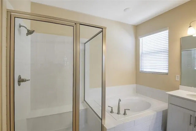 a white bath tub sitting next to a shower