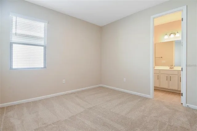an empty room with a bathroom and a sink