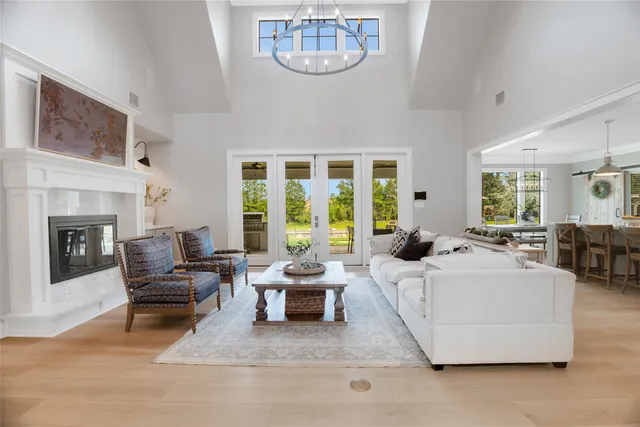 a living room with furniture a fireplace and a large window