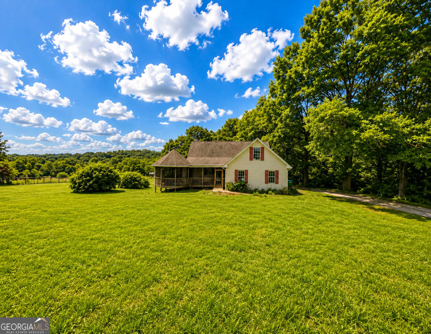 2433 Bear Creek Road Statham, GA 30666 - Photo 1 of 58 a front view of a house with a garden