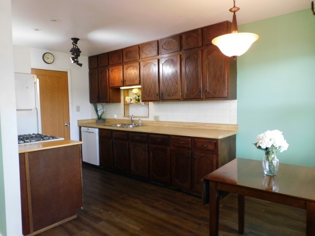 1419 Main Street Spring Grove, IL 60081 - Photo 6 of 27 a kitchen with kitchen island granite countertop a sink cabinets and stainless steel appliances