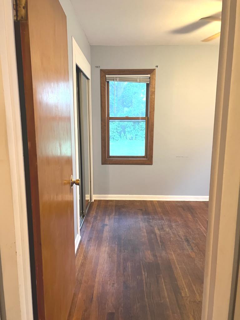 1419 Main Street Spring Grove, IL 60081 - Photo 10 of 27 a view of an empty room with wooden floor and a window