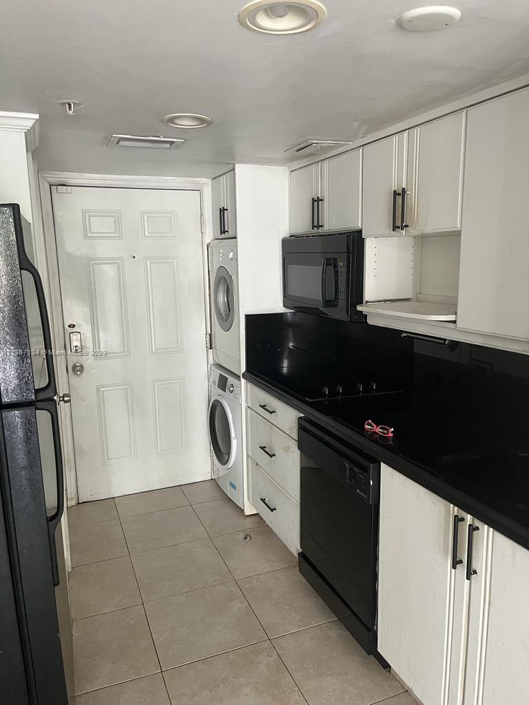 450 Southwest 3rd Street, Unit 4 Miami, FL 33130 - Photo 4 of 10 a kitchen with a refrigerator and a sink