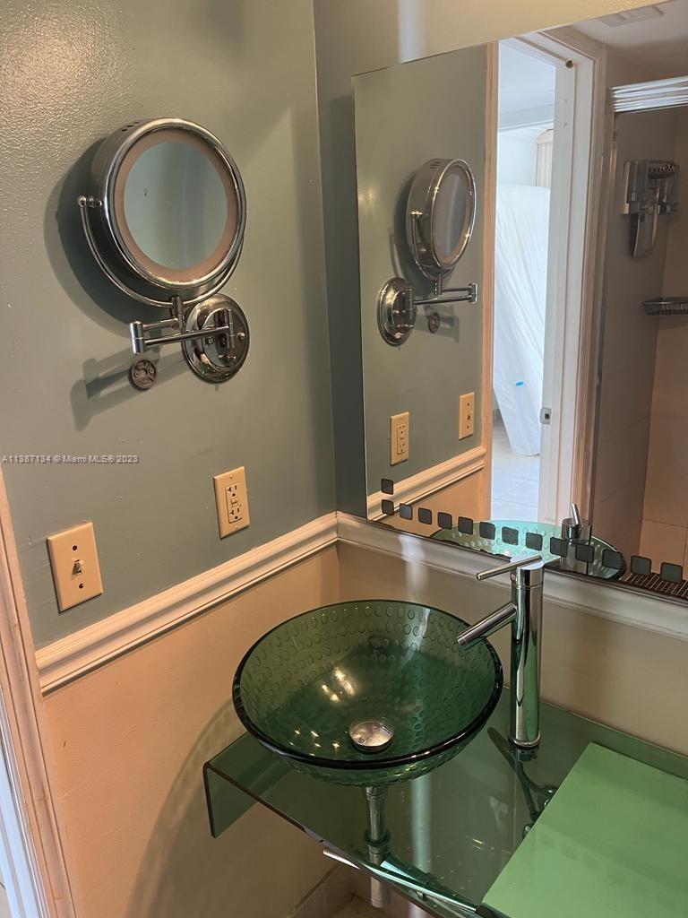 450 Southwest 3rd Street, Unit 4 Miami, FL 33130 - Photo 7 of 10 a bathroom with a sink and a mirror