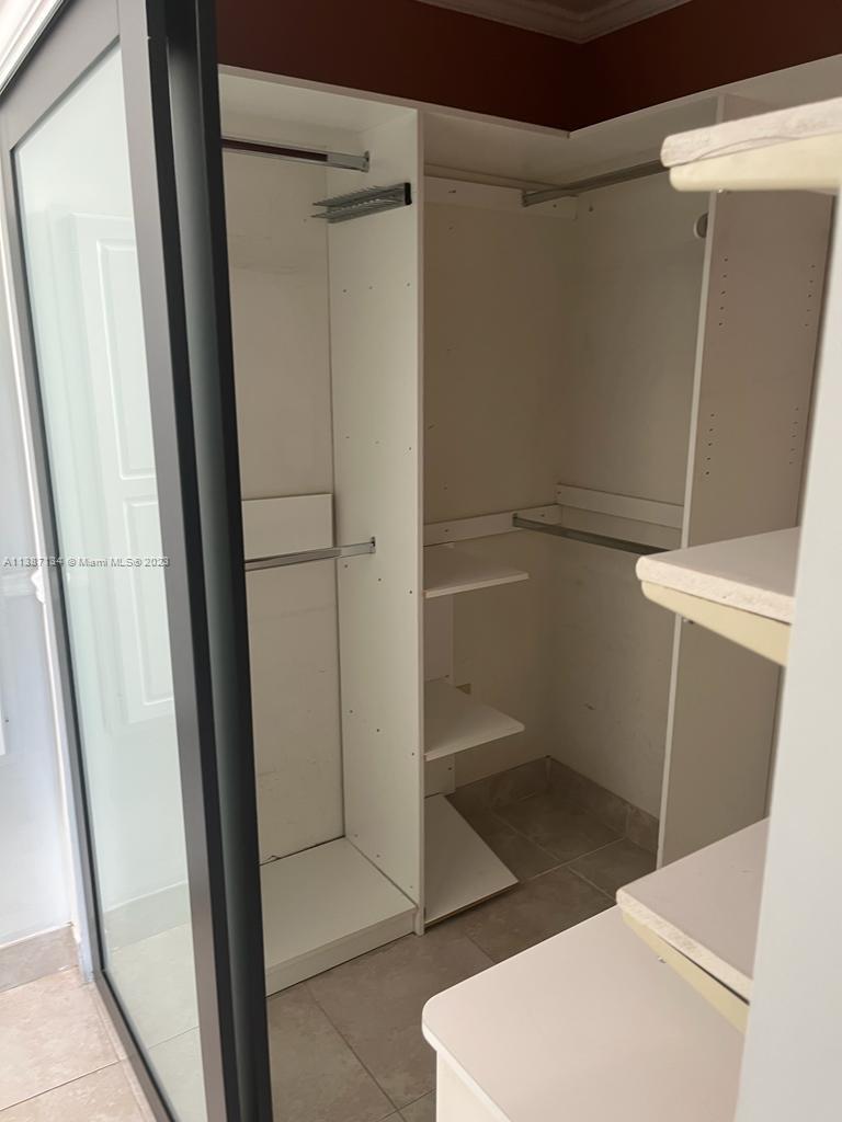 450 Southwest 3rd Street, Unit 4 Miami, FL 33130 - Photo 8 of 10 a bathroom with a glass door shower and toilet