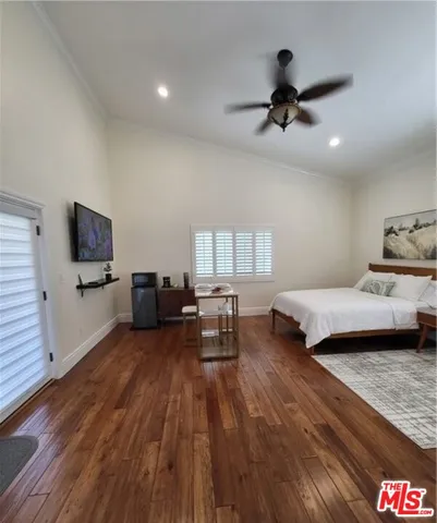 a bedroom with furniture and a wooden floor