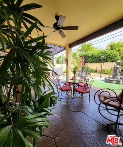 a view of a chairs and table in patio with a yard