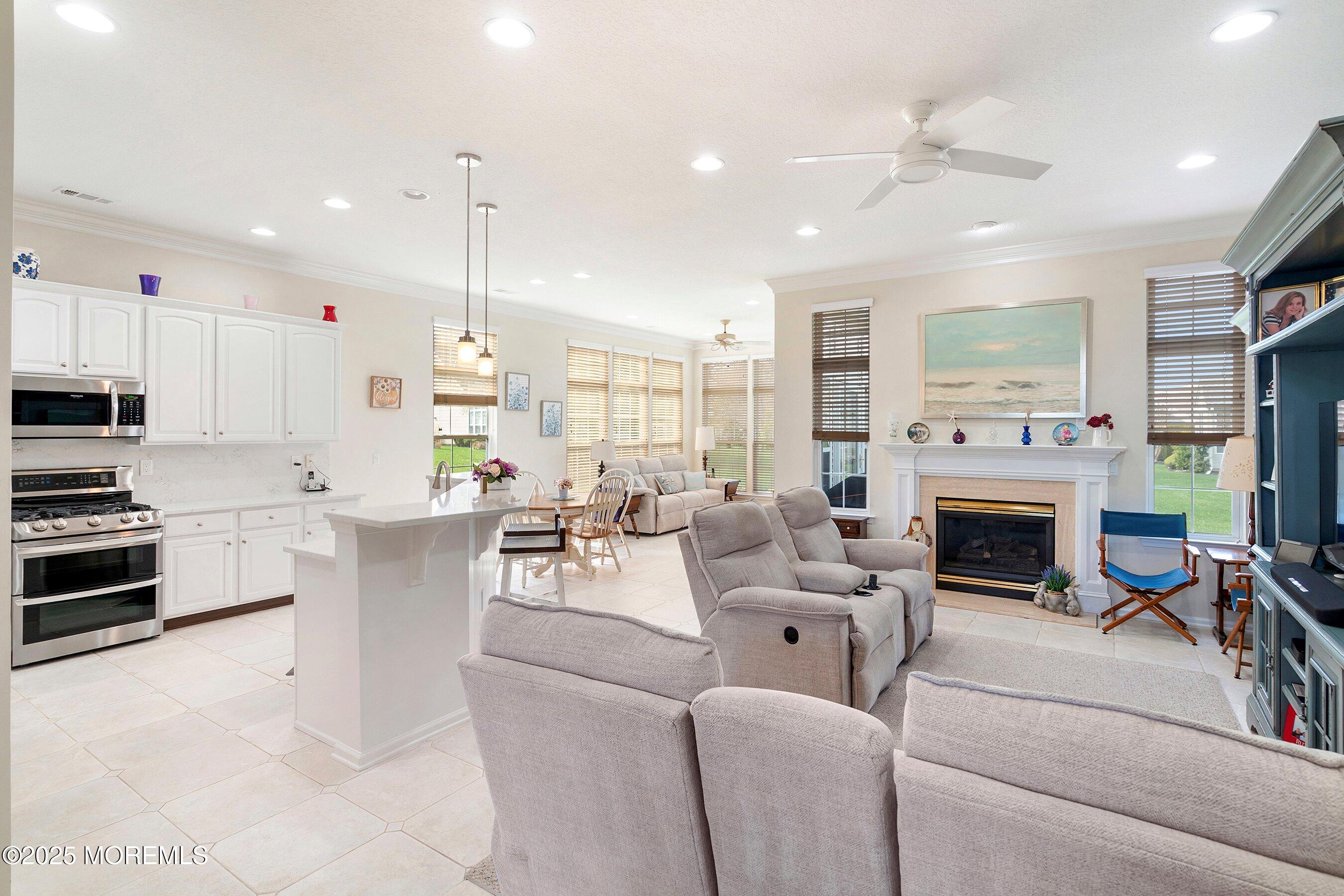 1518 Rabbit Run Manasquan, NJ 08736 - Photo 13 of 54 a living room with furniture a fireplace and a open kitchen view