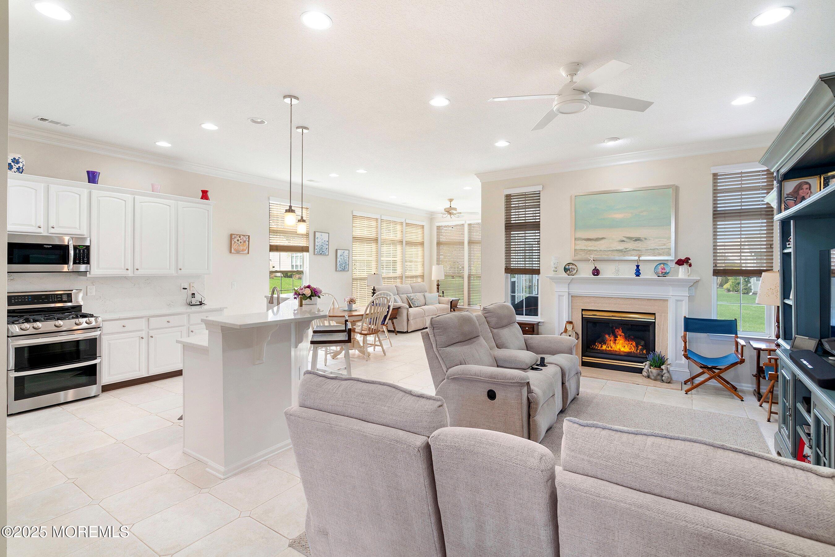 1518 Rabbit Run Manasquan, NJ 08736 - Photo 14 of 54 a living room with furniture a fireplace and a open kitchen view