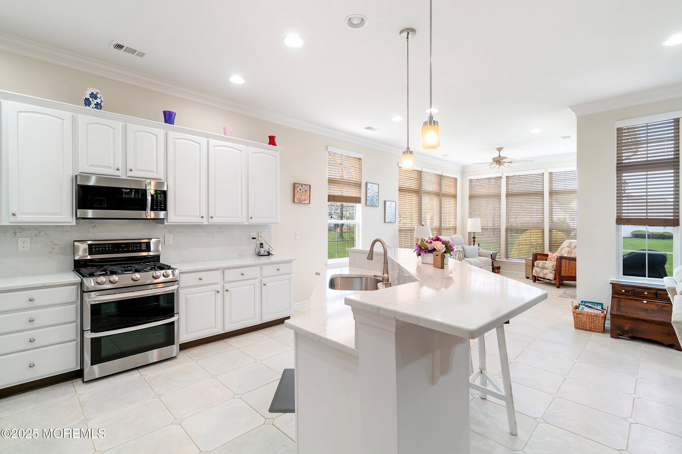 1518 Rabbit Run Manasquan, NJ 08736 - Photo 16 of 54 a kitchen with stainless steel appliances kitchen island granite countertop a sink and cabinets