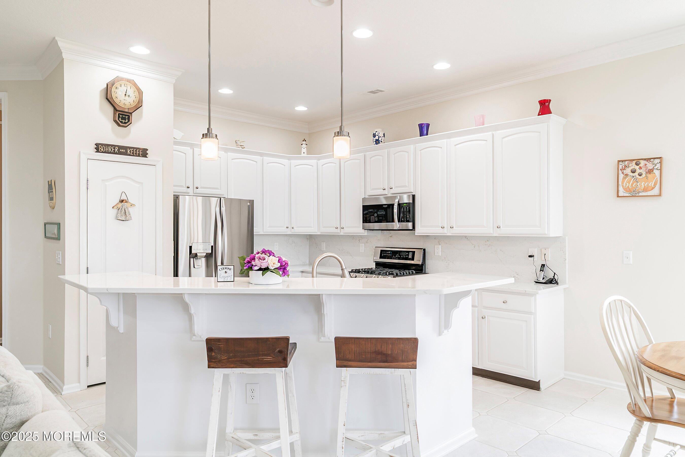 1518 Rabbit Run Manasquan, NJ 08736 - Photo 17 of 54 a kitchen with stainless steel appliances kitchen island granite countertop a sink and cabinets