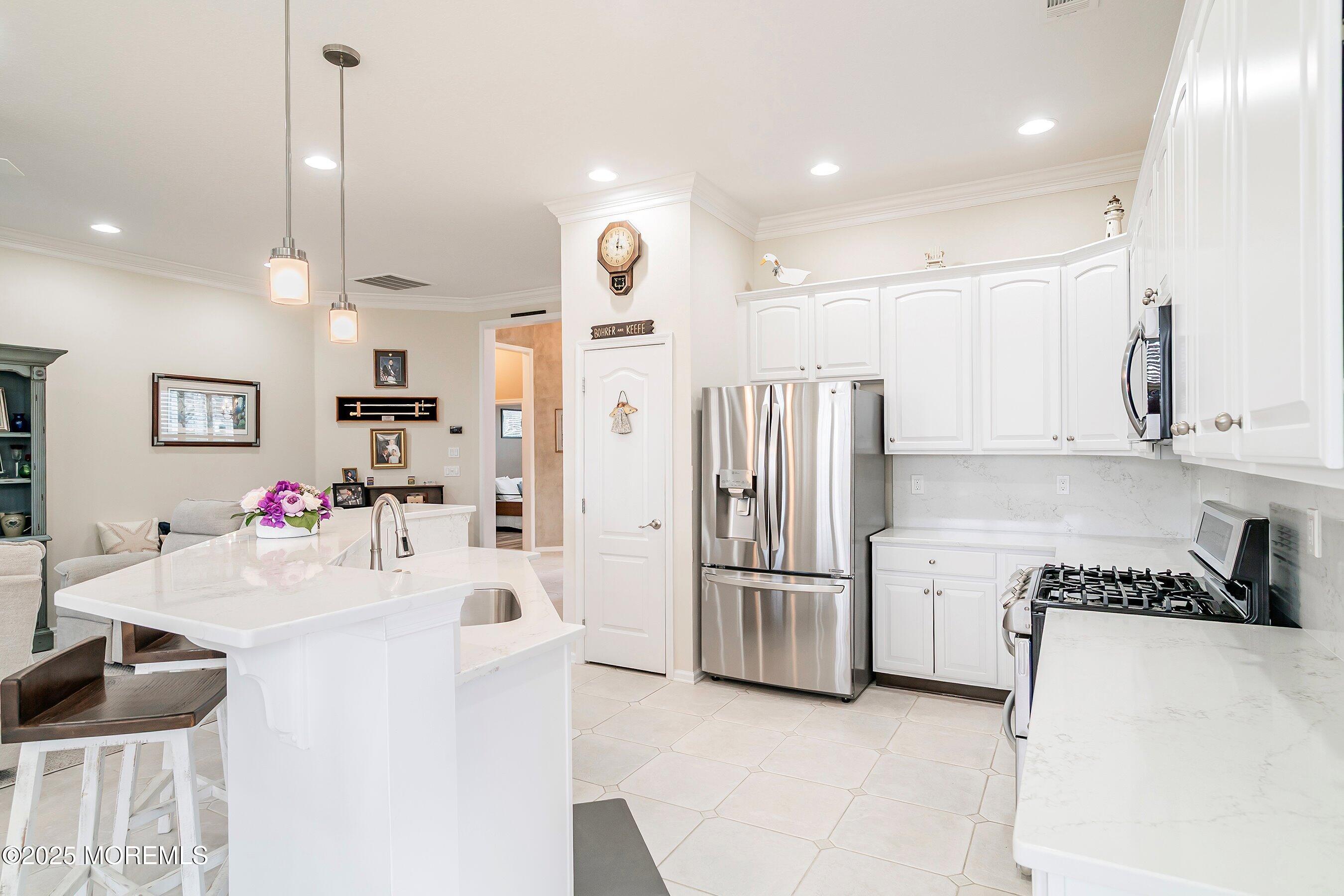 1518 Rabbit Run Manasquan, NJ 08736 - Photo 18 of 54 a kitchen with stainless steel appliances kitchen island granite countertop a refrigerator and a stove top oven