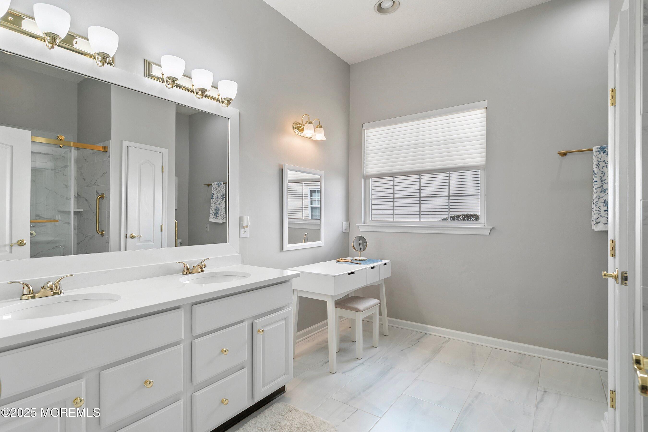 1518 Rabbit Run Manasquan, NJ 08736 - Photo 27 of 54 a spacious bathroom with a double vanity sink a large mirror and a bathtub