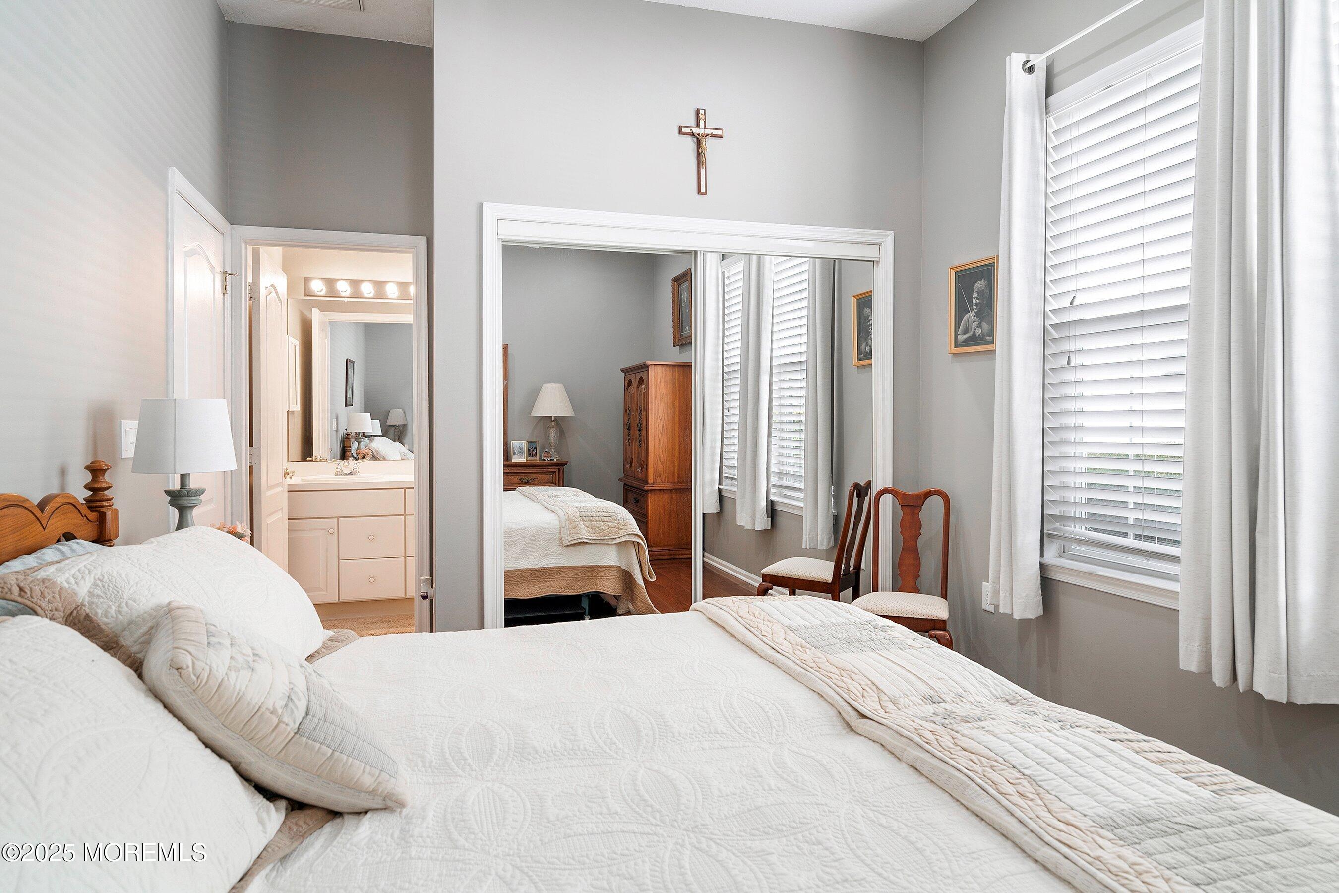 1518 Rabbit Run Manasquan, NJ 08736 - Photo 31 of 54 a bedroom with a bed and a large mirror