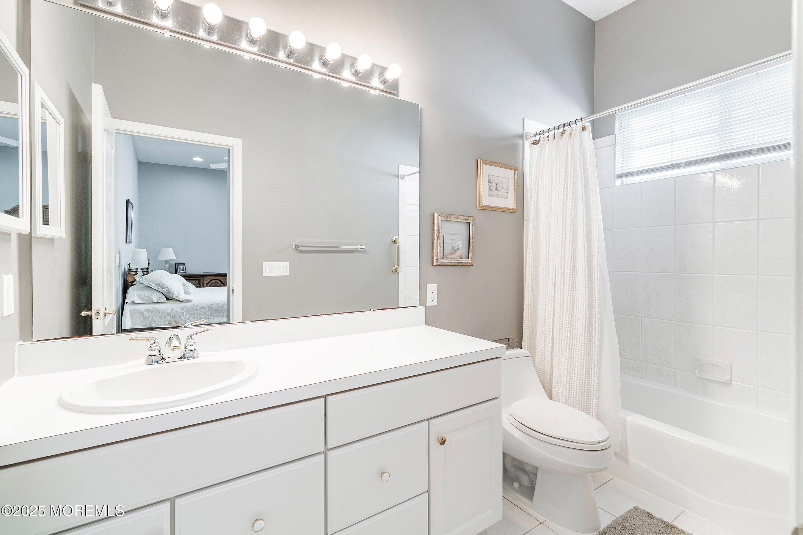 1518 Rabbit Run Manasquan, NJ 08736 - Photo 32 of 54 a bathroom with a sink a toilet a mirror and shower