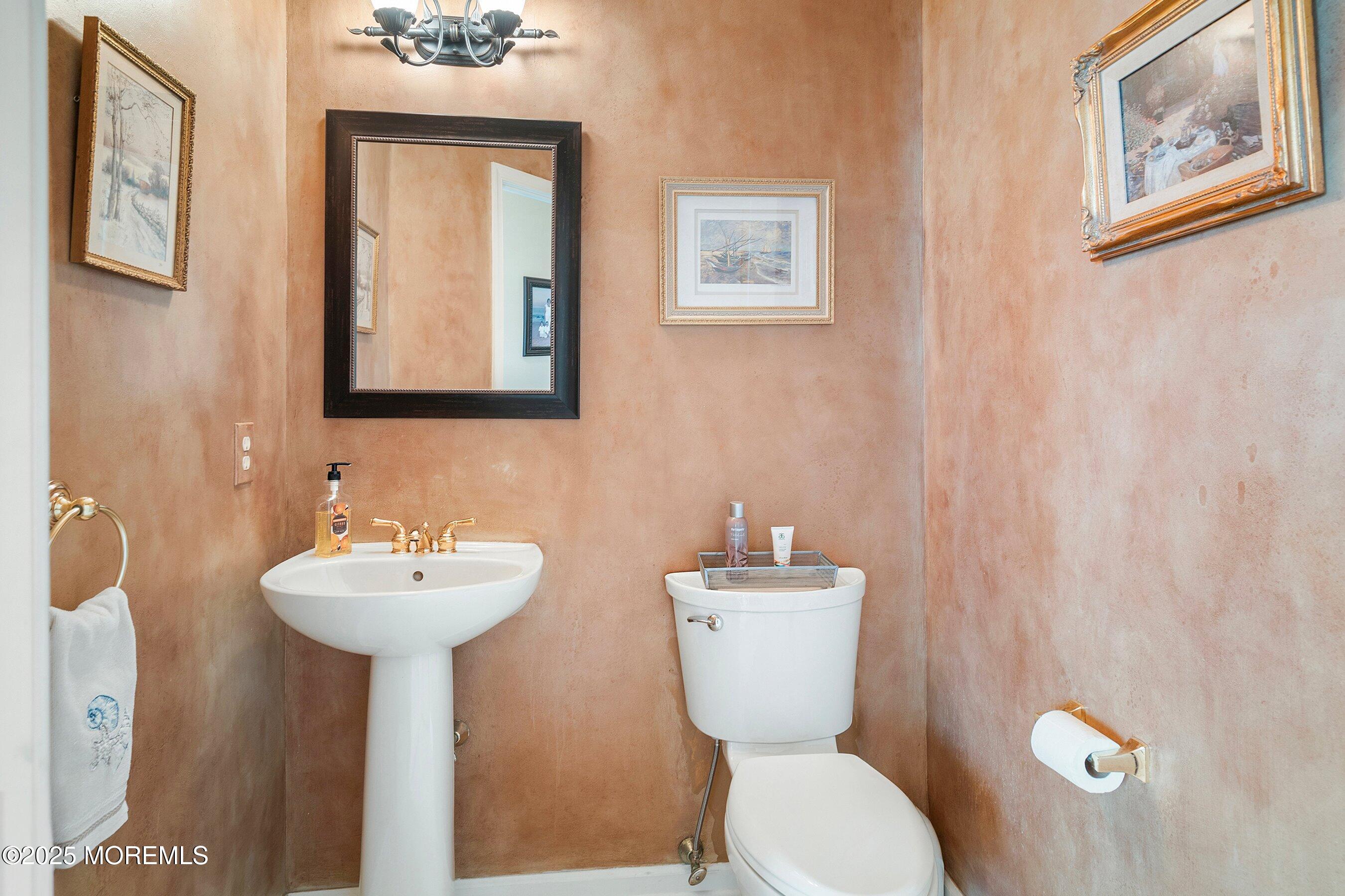 1518 Rabbit Run Manasquan, NJ 08736 - Photo 34 of 54 a bathroom with a toilet sink and mirror