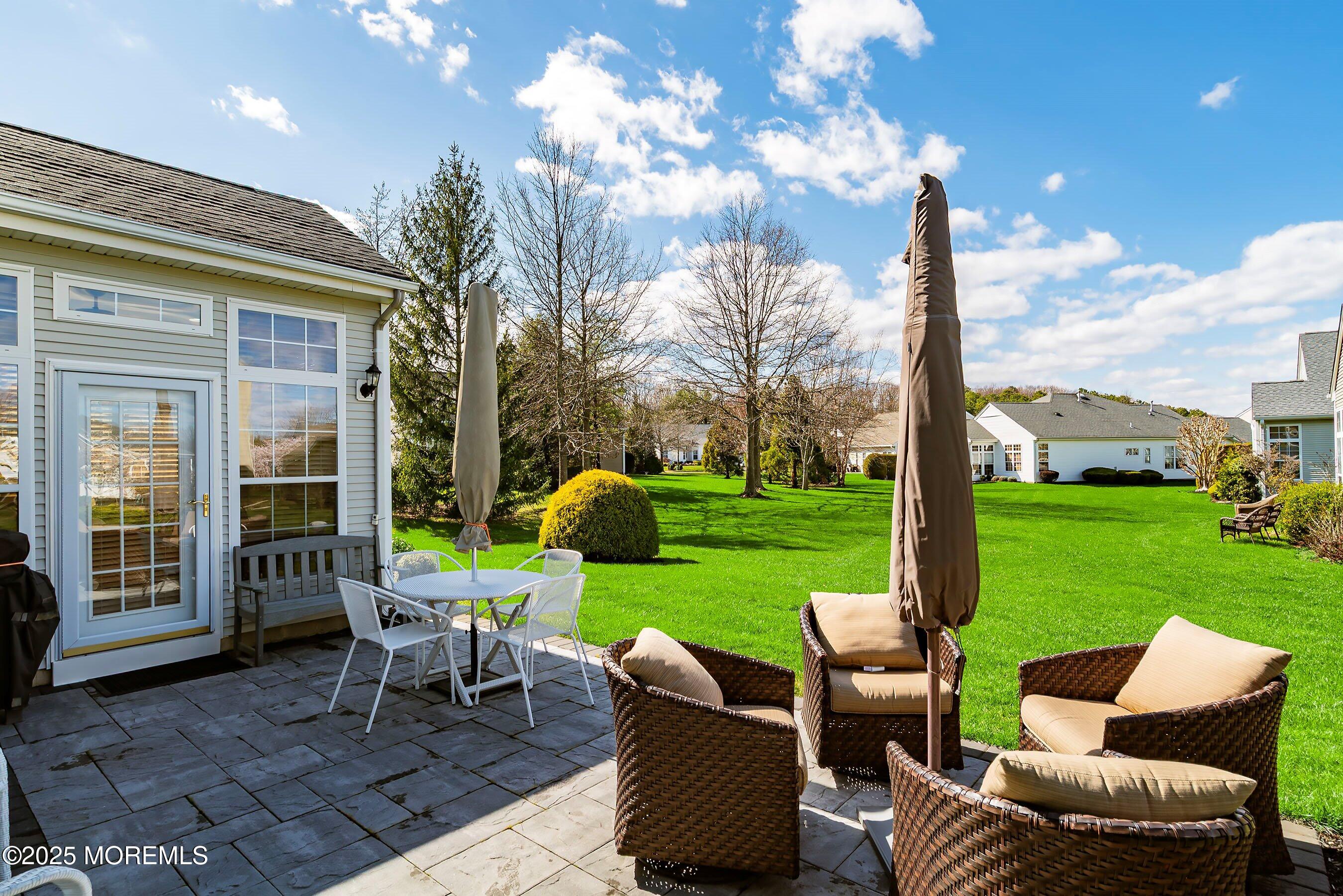 1518 Rabbit Run Manasquan, NJ 08736 - Photo 36 of 54 a view of a patio with chairs and a table