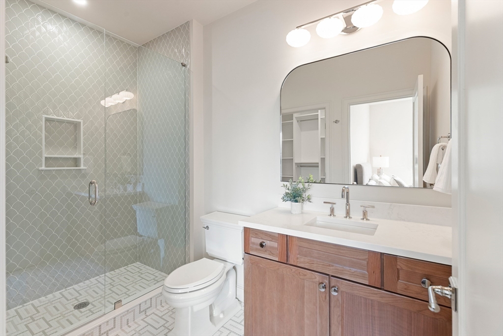 8 Common Court Lexington, MA 02421 - Photo 24 of 31 a bathroom with a sink a toilet and shower