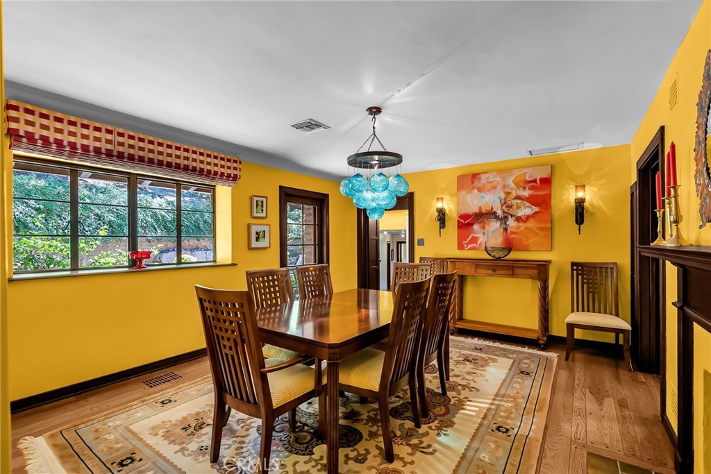6146 Hawarden Drive Riverside, CA 92506 - Photo 22 of 75 a view of a dining room with furniture a chandelier and wooden floor