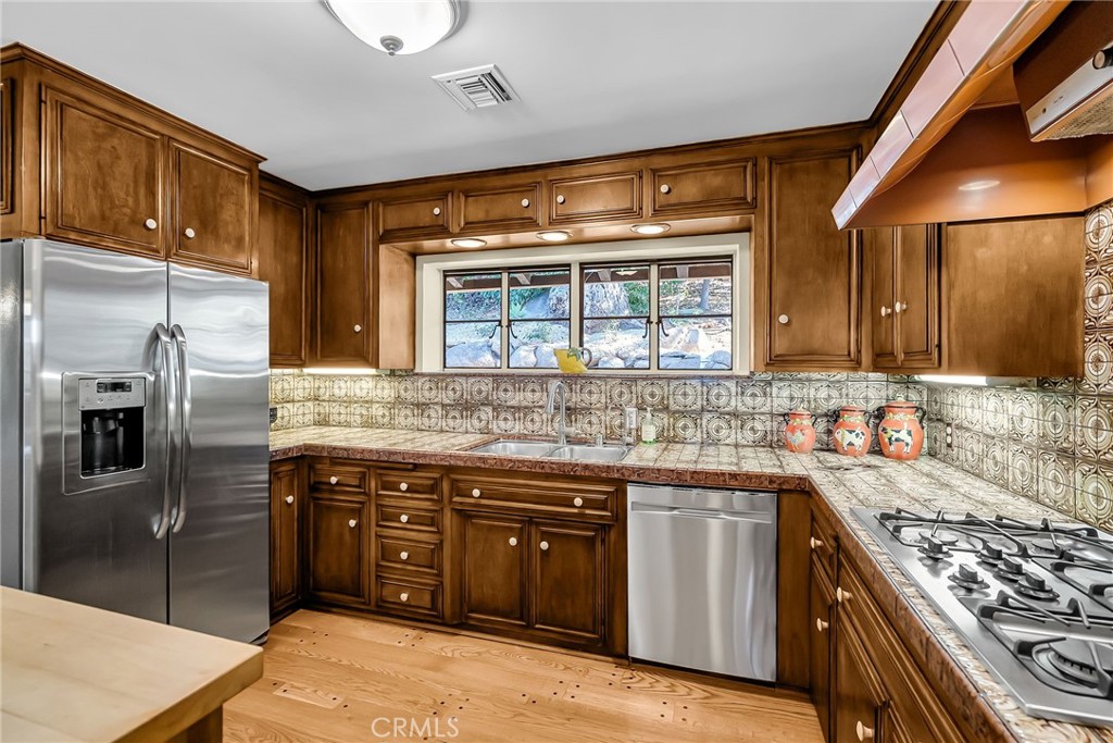 6146 Hawarden Drive Riverside, CA 92506 - Photo 26 of 75 a kitchen with a sink stove and refrigerator