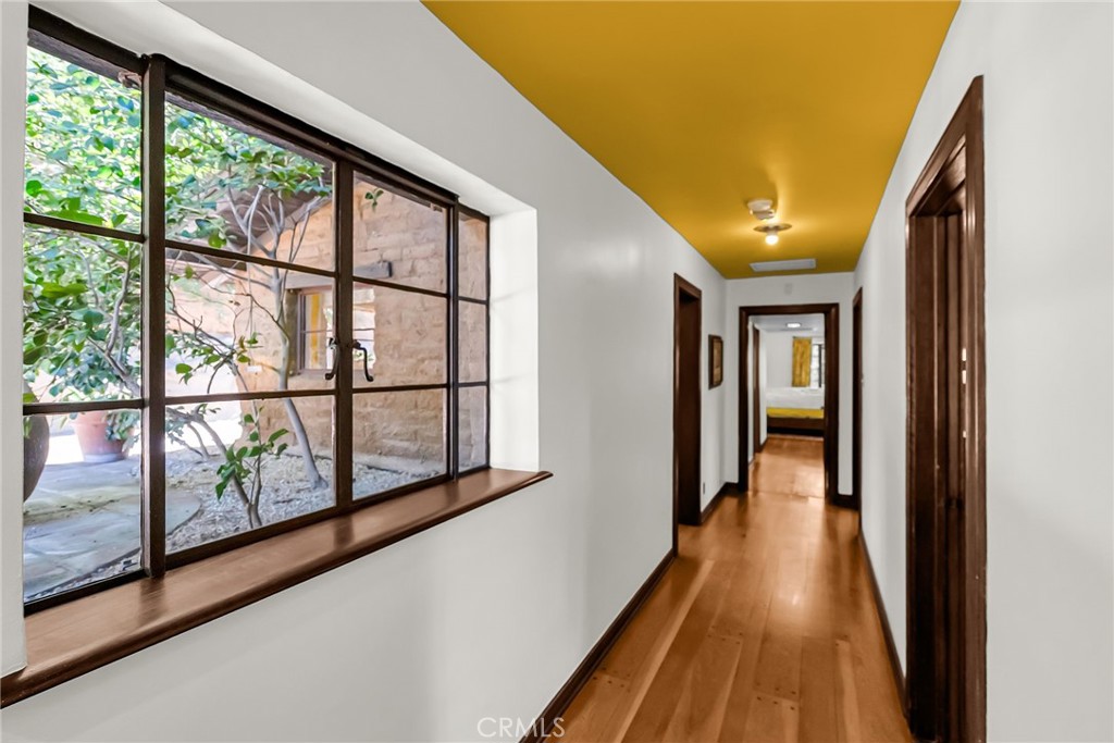 6146 Hawarden Drive Riverside, CA 92506 - Photo 31 of 75 a view of a hallway with wooden floor and staircase