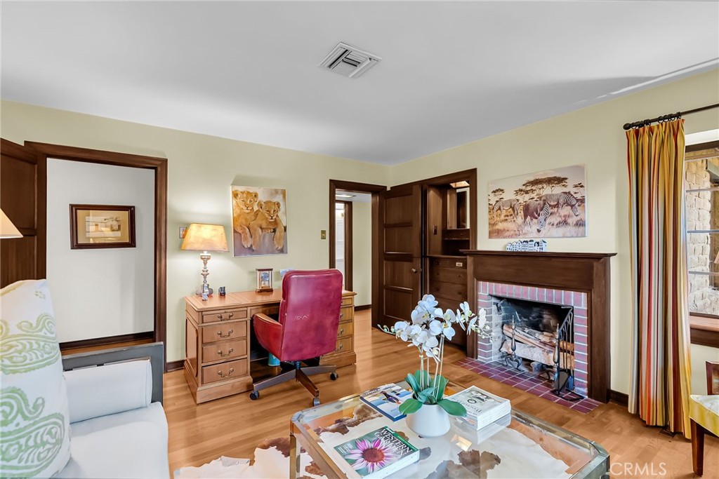 6146 Hawarden Drive Riverside, CA 92506 - Photo 36 of 75 a living room with furniture a fireplace and a flat screen tv