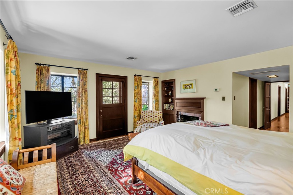 6146 Hawarden Drive Riverside, CA 92506 - Photo 37 of 75 a spacious bedroom with a bed and a flat screen tv