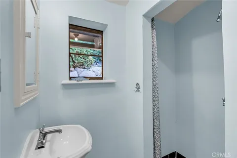 a view of a patio with lawn chairs under an umbrella