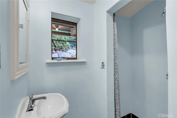 a view of a patio with lawn chairs under an umbrella