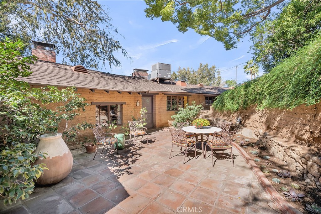 6146 Hawarden Drive Riverside, CA 92506 - Photo 44 of 75 a view of a patio with table and chairs and potted plants