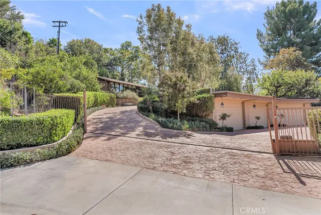 a living room with furniture a fireplace and large windows