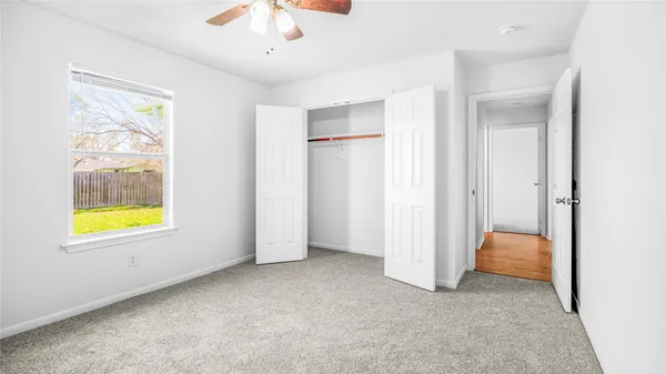 a view of room with window and ceiling fan