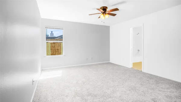 a view of an empty room and a window