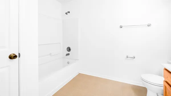 a bathroom with a bathtub and toilet