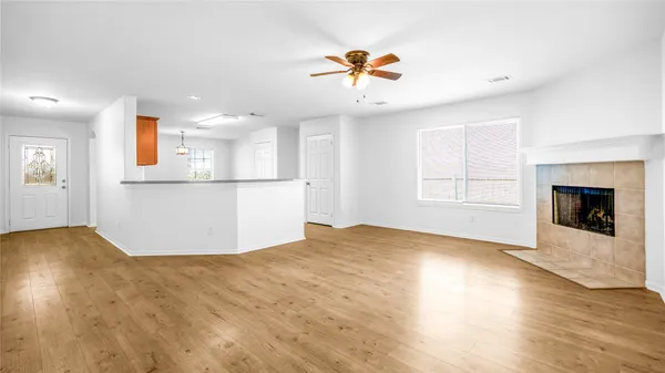 a view of a kitchen with a dishwasher cabinets and wooden floor
