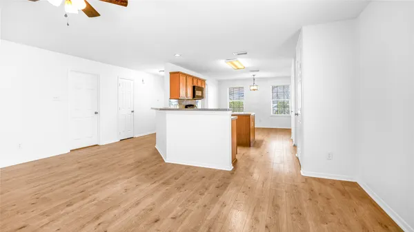 a kitchen with granite countertop a stove a sink and a refrigerator